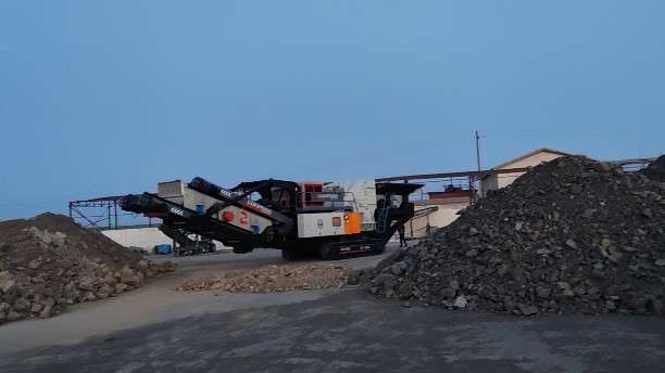 What is the purpose of the hanging screen on the crusher